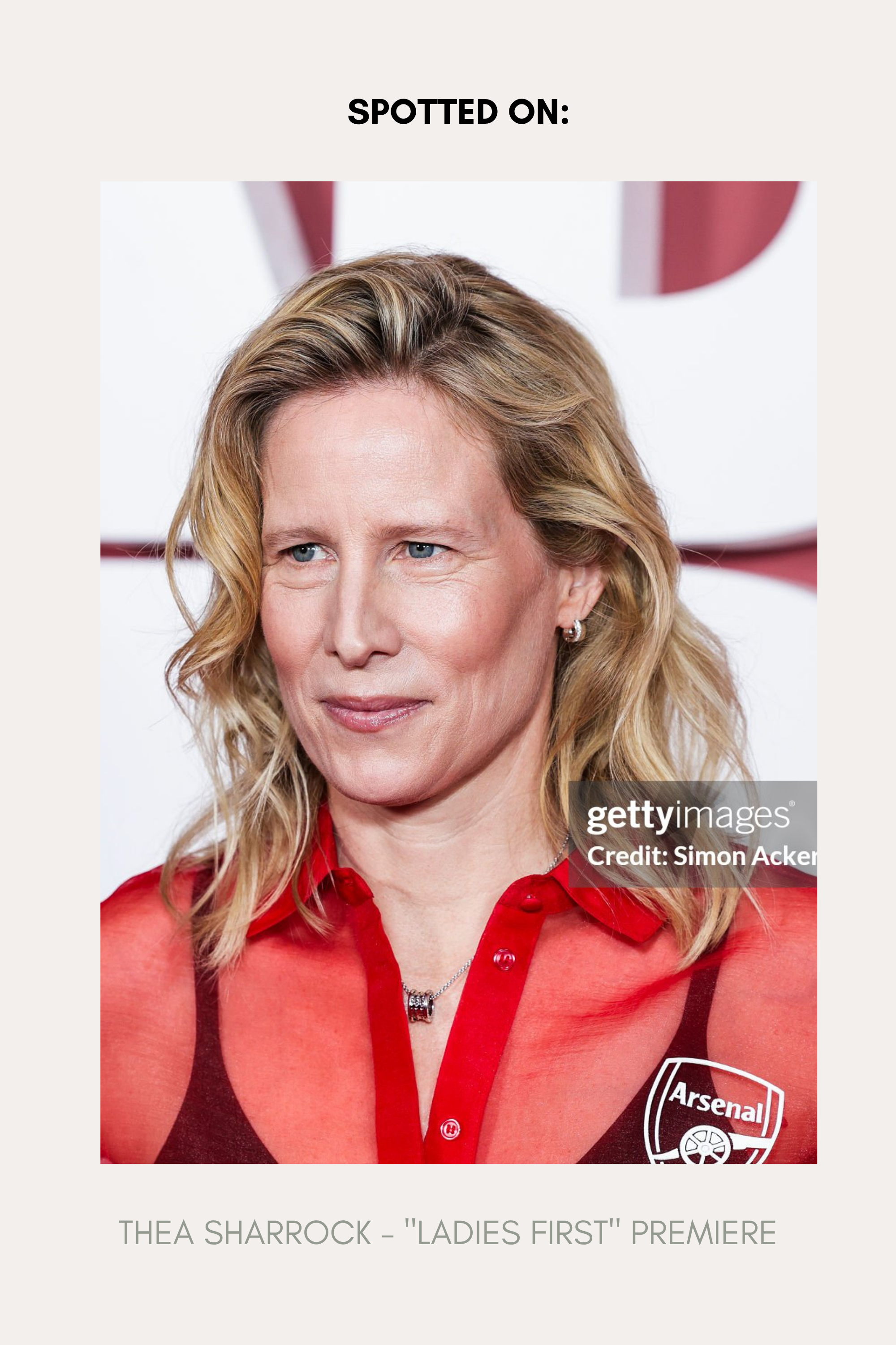 A woman with wavy blonde hair wears Juni Pavé Chunky Huggie Earrings in Gold and a sheer red blouse at an event. Text reads: SPOTTED ON: THEA SHARROCK – LADIES FIRST PREMIERE. A Getty Images watermark is visible.