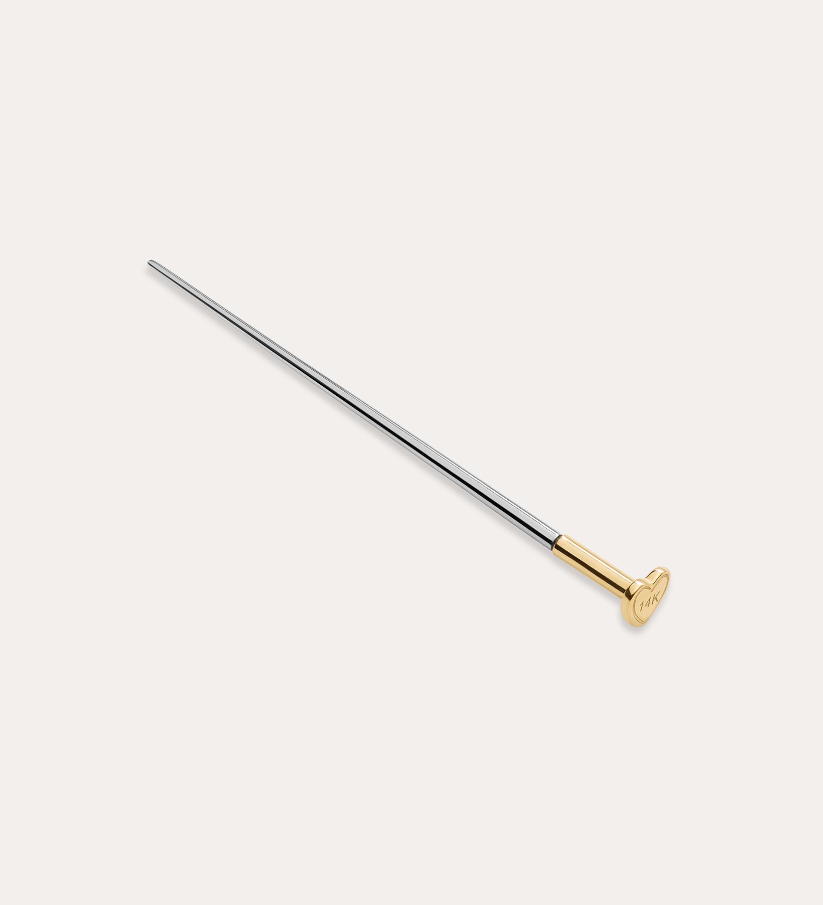 The Vanchi Labret Piercing Taper Care Set features a long, slender metal taper with a gold-toned circular end, displayed diagonally on a plain white background.