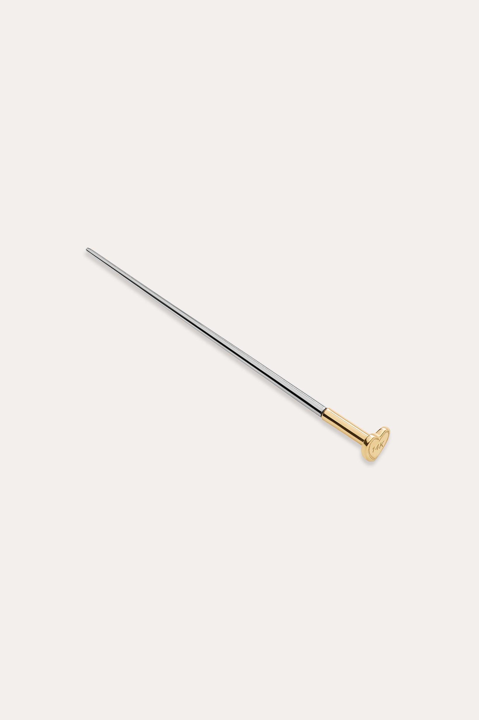 The Vanchi Labret Piercing Taper Care Set features a long, slender metal taper with a gold-toned circular end, displayed diagonally on a plain white background.
