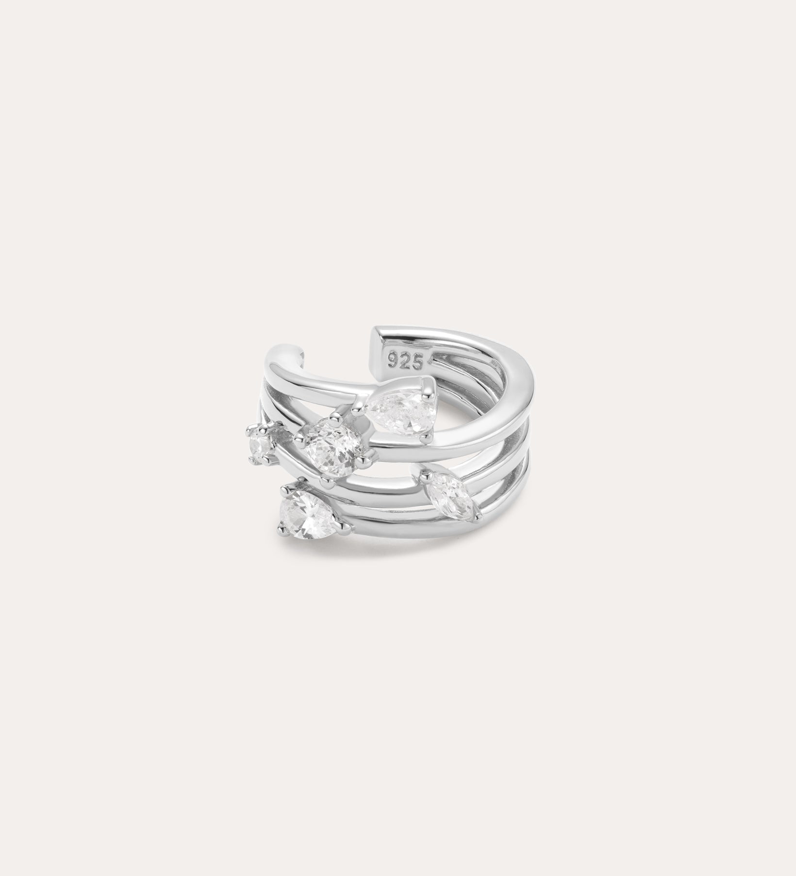 The Vale Crystal Ear Cuff in Silver features three parallel bands accented with five clear, uniquely shaped gemstones, shown against a light background.