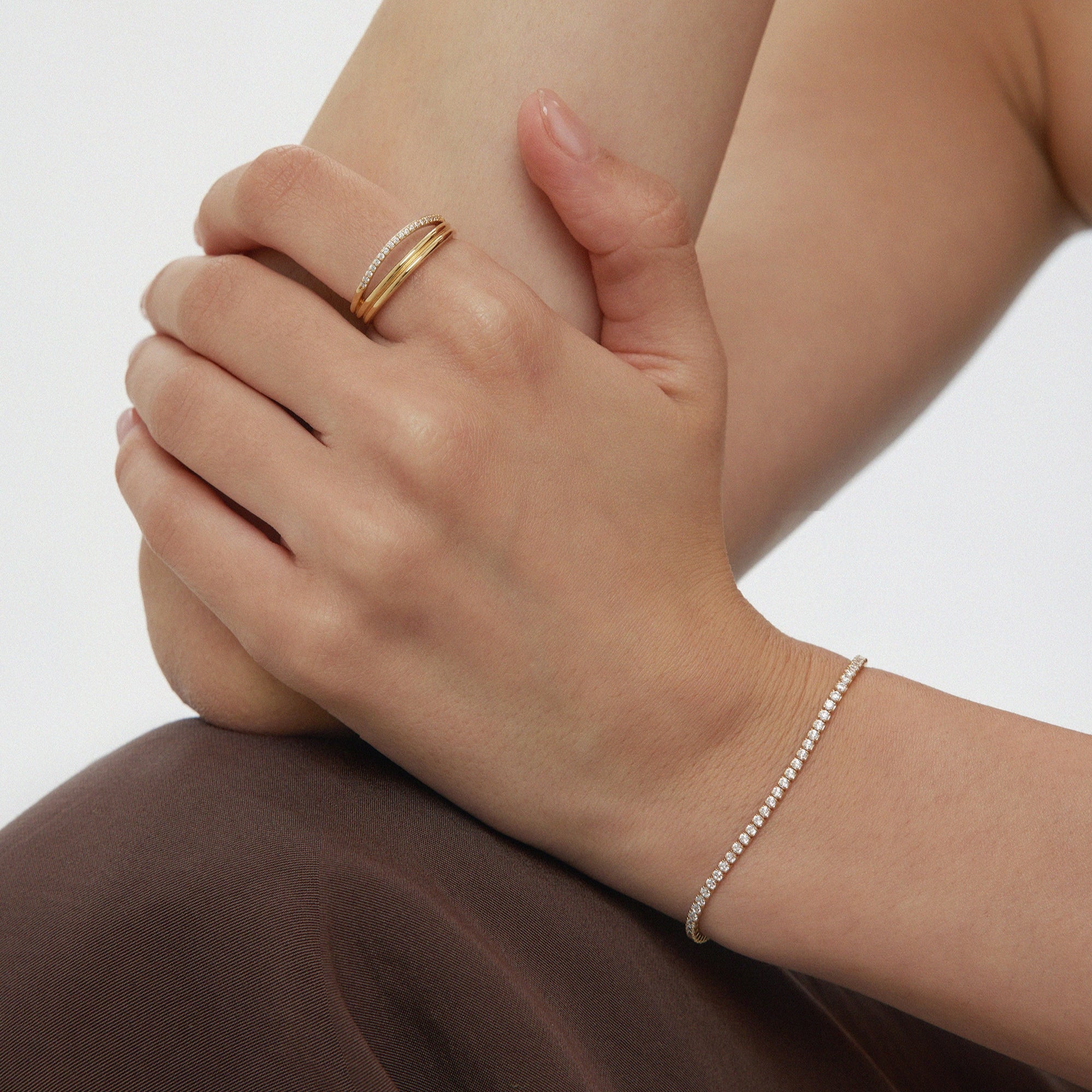 Gold tennis bracelet with stacking ring