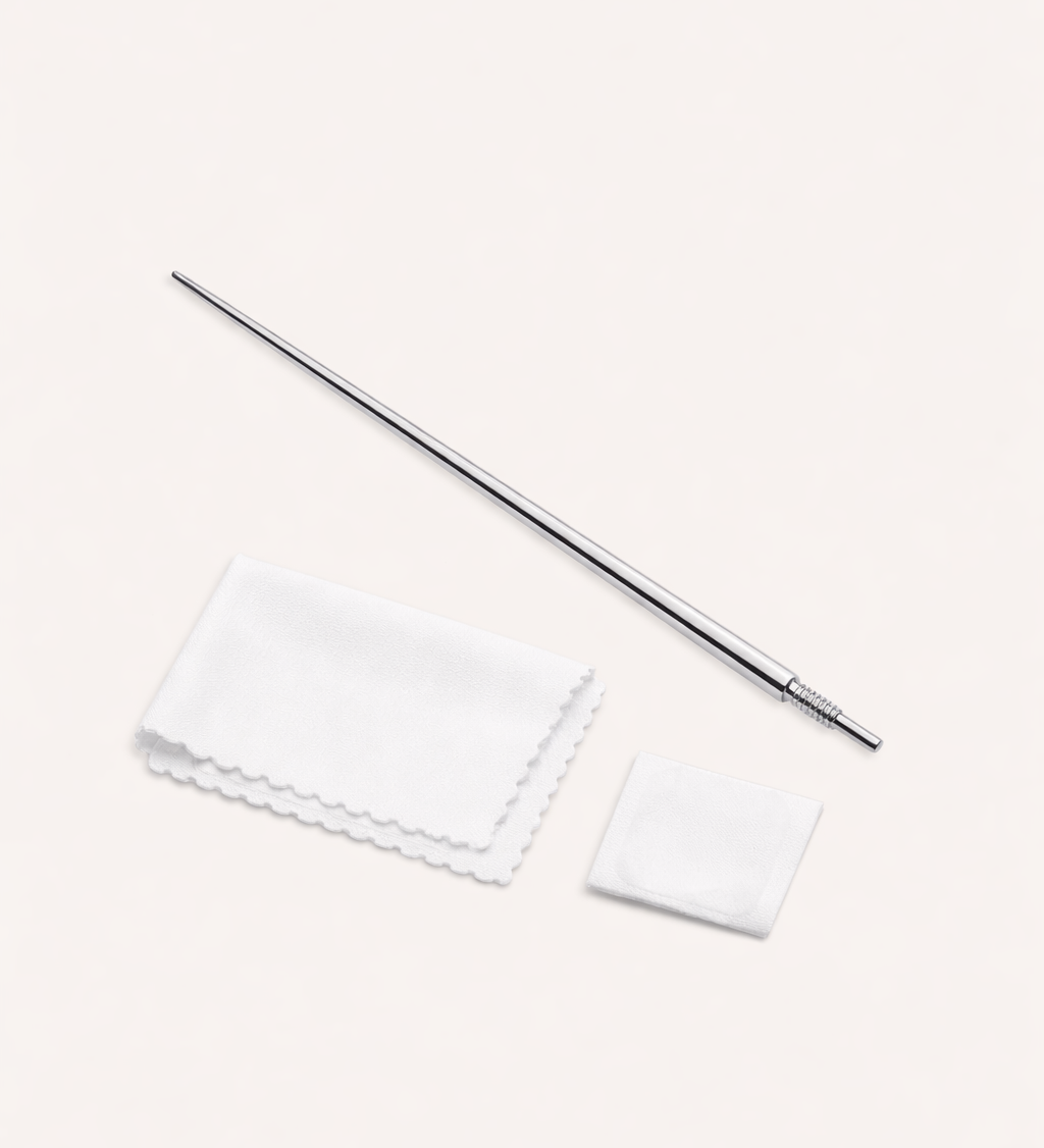 The Vanchi Labret Piercing Taper Care Set, featuring a metal taper with textured grip, is shown above a folded white cloth and small square pad on a light surface.