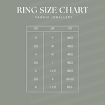 Ring size chart for the Willa Heart Signet Pinky Ring in Silver, displaying US sizes 3–6, UK sizes F–L 1/2, and EU sizes 44.0–51.5 on a green background—ideal for finding your perfect pinky ring fit.
