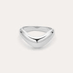 The Vava Plain Chunky Curved Wave Ring in Silver features a polished, silver V-shaped wave design with a smooth, rounded surface. Photographed against a light background, its ideal for minimalist jewelry lovers.