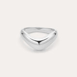 The Vava Plain Chunky Curved Wave Ring in Silver features a polished, silver V-shaped wave design with a smooth, rounded surface. Photographed against a light background, its ideal for minimalist jewelry lovers.