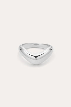 The Vava Plain Chunky Curved Wave Ring in Silver features a polished, silver V-shaped wave design with a smooth, rounded surface. Photographed against a light background, its ideal for minimalist jewelry lovers.