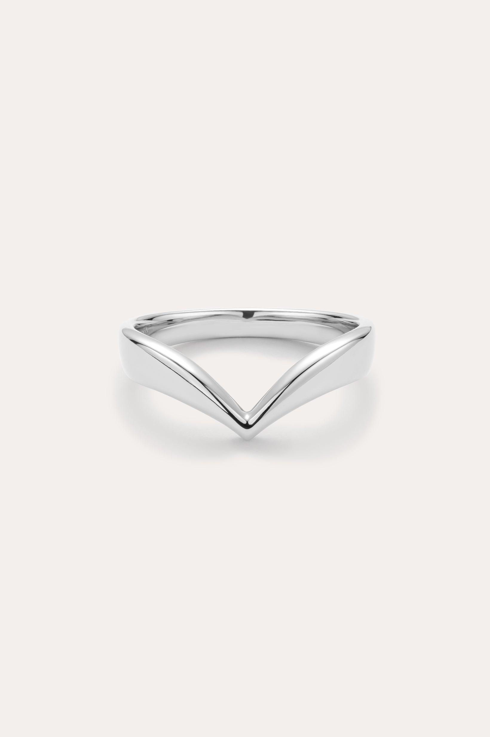 The Veda Plain Chevron Ring in Silver features a minimalist, V-shaped sterling silver design, showcased against a simple light background.