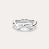 The Vica Fluid Wave Chunky Band Ring in Silver, featuring a smooth, wavy design, is displayed against a plain light background.