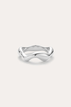 The Vica Fluid Wave Chunky Band Ring in Silver, featuring a smooth, wavy design, is displayed against a plain light background.