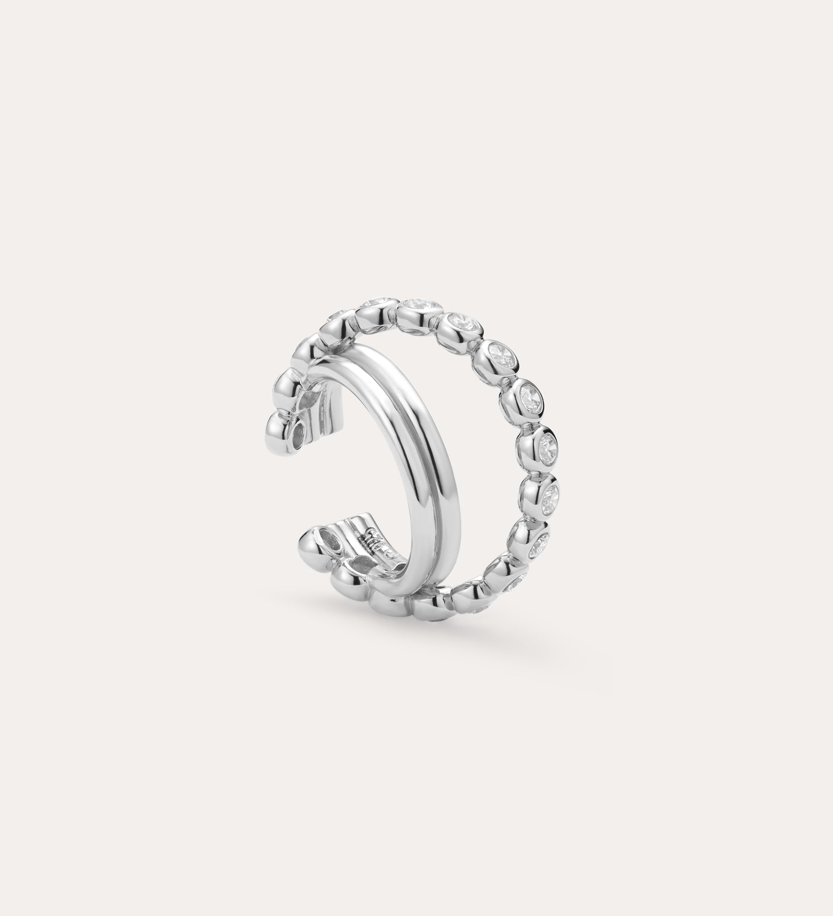 Pair the Vina Crystal Bezel Ear Cuff in Silver with a chic open silver ring, featuring one smooth band and another band dotted with sparkling cubic zirconia stones for a coordinated, stylish look.