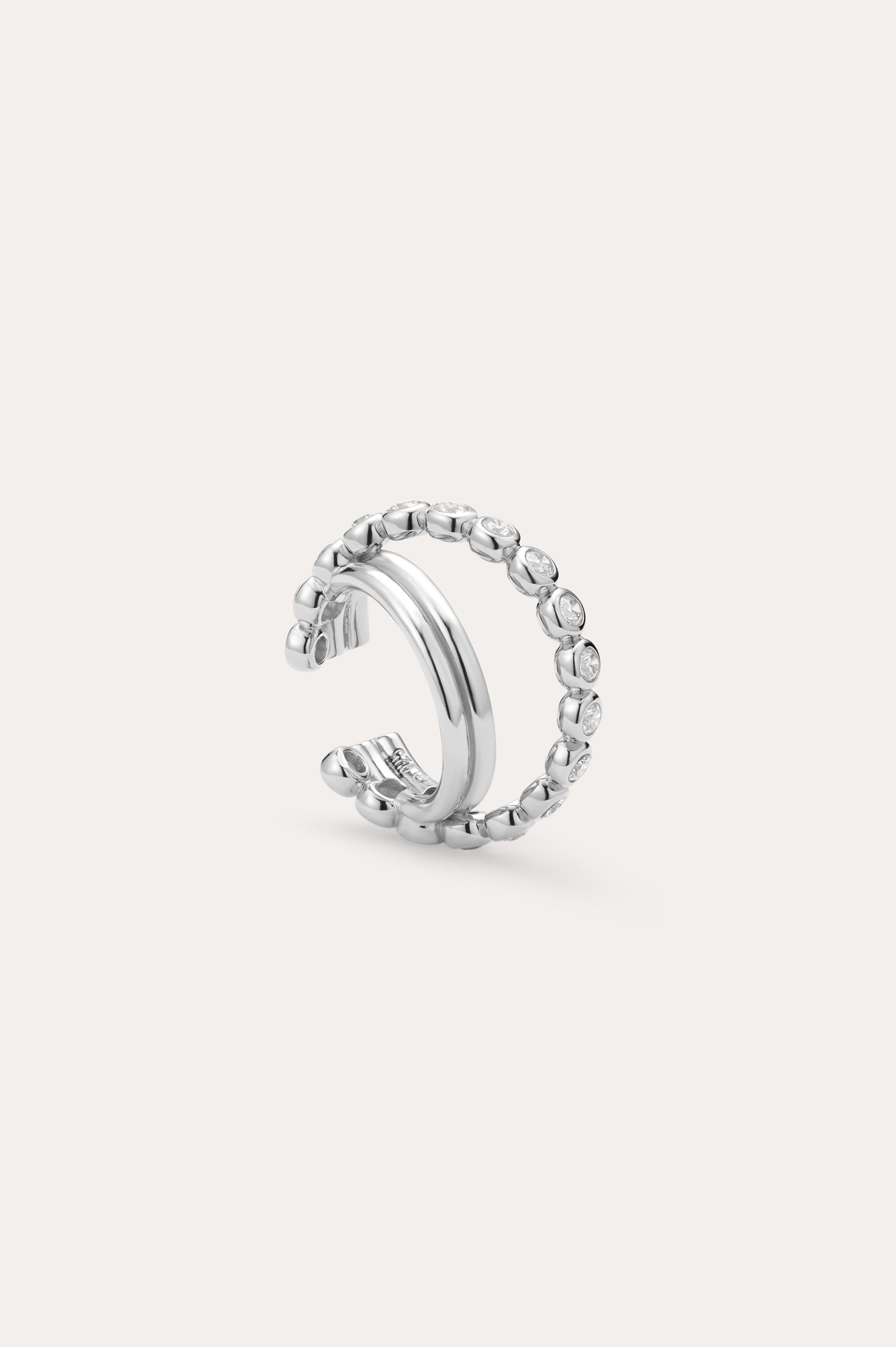 Pair the Vina Crystal Bezel Ear Cuff in Silver with a chic open silver ring, featuring one smooth band and another band dotted with sparkling cubic zirconia stones for a coordinated, stylish look.