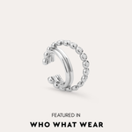 The Vina Crystal Bezel Ear Cuff in Silver, a non-pierced ear cuff with a beaded design, is shown on a light background and has been featured in Who What Wear.
