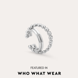 The Vina Crystal Bezel Ear Cuff in Silver, a non-pierced ear cuff with a beaded design, is shown on a light background and has been featured in Who What Wear.