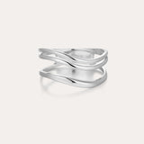 The Zoe Triple Wave Ring in Silver is a minimalist piece made from recycled sterling silver, featuring three polished, overlapping bands and shown against a plain light background.