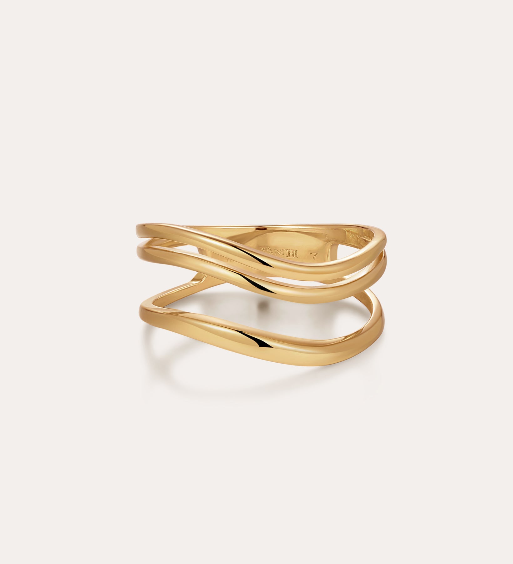 The Zoe Triple Wave Ring in Gold features three slim, wavy gold-plated bands intertwined for a modern, elegant look against a plain light background.